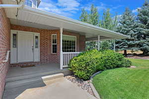 Entrance to property featuring a porch