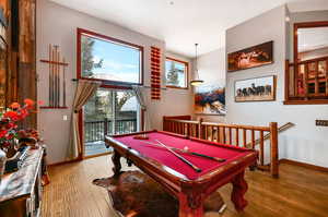 Recreation room featuring light wood-type flooring, baseboards, and pool table