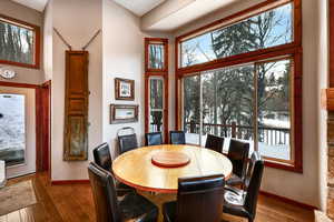 Dining area with hardwood / wood-style flooring and baseboards