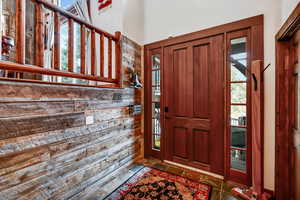 Foyer entrance featuring a wealth of natural light and stone tile floors