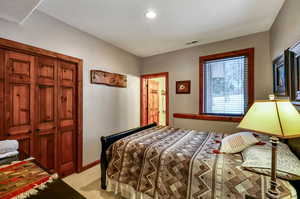 Bedroom with visible vents and light colored carpet