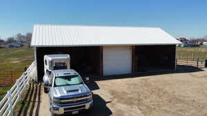 Detached garage featuring fence