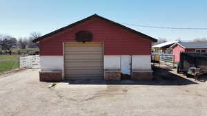 View of outbuilding with an outbuilding and fence