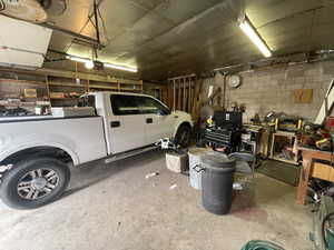 Garage with a garage door opener and concrete block wall