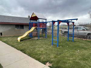 Community playground featuring fence and a yard