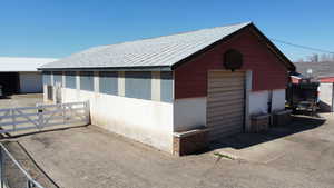 View of outbuilding featuring an outdoor structure and fence