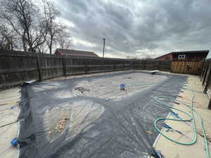 View of pool with a storage shed, a fenced in pool, a fenced backyard, an outbuilding, and a diving board