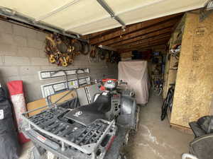 Garage featuring concrete block wall