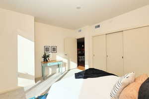 Bedroom with light colored carpet