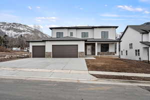 Prairie-style home with a garage, covered porch, concrete driveway, and stucco siding