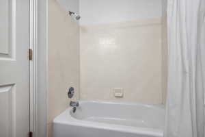 Full bath featuring shower / bath combination with curtain