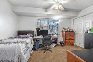 Private Bedroom - Carpeted bedroom featuring ceiling fan, a closet, and a textured ceiling