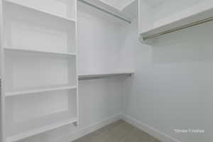 Walk in closet with carpet flooring