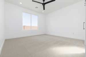 Empty room with light carpet, ceiling fan, visible vents, and recessed lighting