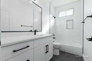 Bathroom featuring shower / bath combination, vanity, toilet, and tile patterned floors