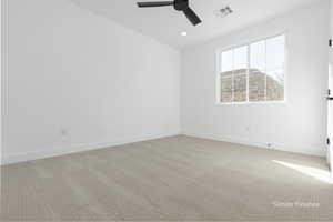 Empty room featuring recessed lighting, baseboards, visible vents, and light colored carpet