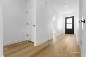 Entrance foyer featuring recessed lighting, light wood-style flooring, and baseboards