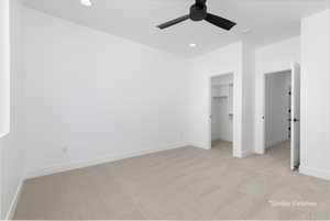 Unfurnished bedroom featuring recessed lighting, a spacious closet, light carpet, ceiling fan, and baseboards