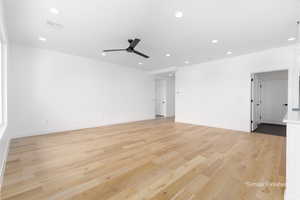 Empty room featuring visible vents, baseboards, light wood-style flooring, ceiling fan, and recessed lighting