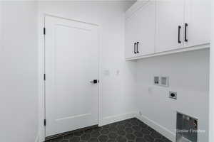 Laundry area with washer hookup, cabinet space, hookup for an electric dryer, and baseboards