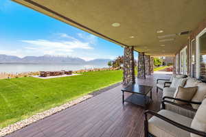 View of patio / terrace featuring visible vents, an outdoor hangout area, and a water and mountain view