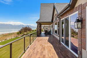 Deck featuring a lawn and a water and mountain view