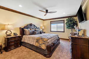 Carpeted bedroom featuring baseboards, recessed lighting, visible vents, and crown molding