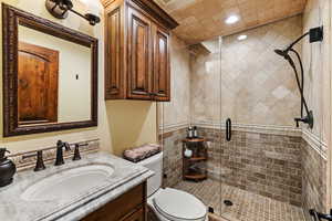 Full bath featuring a stall shower, vanity, toilet, and recessed lighting