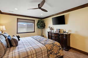 Carpeted bedroom featuring baseboards, visible vents, ceiling fan, ornamental molding, and recessed lighting