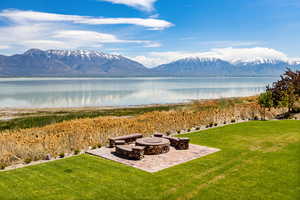 Exterior space with a firepit and lake and mountain views