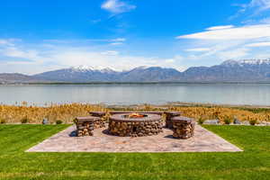 View of patio with a fire pit and a water and mountain view