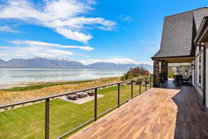 Exterior space with an outdoor fire pit, a water and mountain view, and a yard