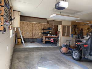 Garage with a workshop area and a garage door opener