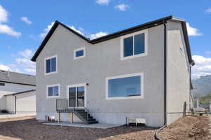 Rear view of property with stucco siding