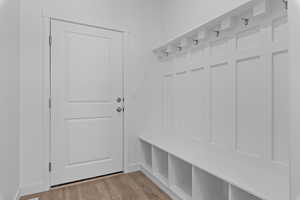 Mudroom with wood finished floors and baseboards