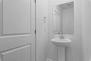 Bathroom featuring a sink and visible vents