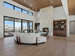 Living area with baseboards, visible vents, wooden ceiling, wood finished floors, and a fireplace