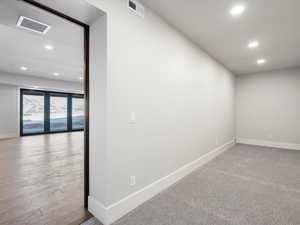 Unfurnished room featuring baseboards, visible vents, and recessed lighting