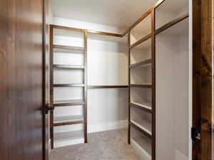 Walk in closet featuring carpet flooring