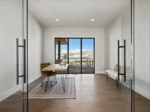 Office with recessed lighting, wood finished floors, a mountain view, and baseboards