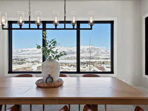 Unfurnished dining area with a mountain view and a chandelier