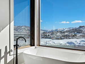 Full bathroom featuring a freestanding tub and a mountain view