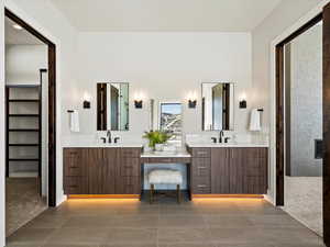 Full bathroom with tile patterned flooring, two vanities, and a sink