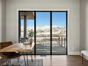 Doorway featuring visible vents, a mountain view, baseboards, and wood finished floors