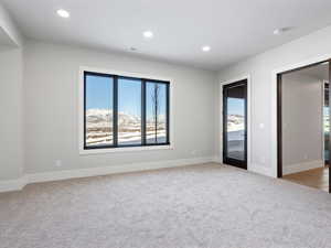 Carpeted empty room with baseboards, visible vents, a wealth of natural light, and recessed lighting