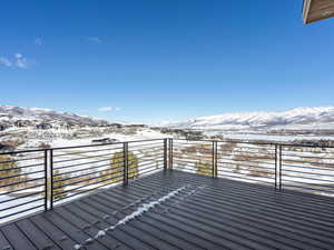 Snow covered deck featuring a mountain view