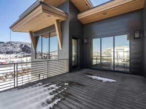 Snow covered deck with a mountain view