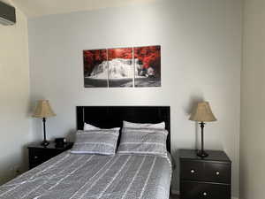 Bedroom featuring a wall mounted AC