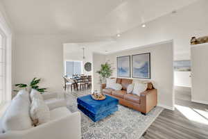 Living area with vaulted ceiling, and wood finished floors