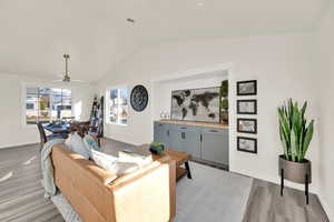 Living room featuring lofted ceiling, light wood-type flooring, and open floor plan